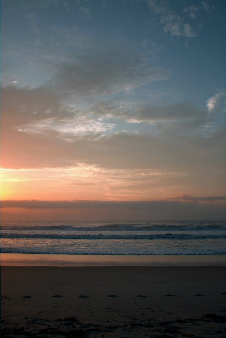 Empty Beach At Cloudy Sunset