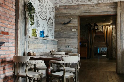 Cozy rustic restaurant scene with wooden decor and cozy seating.