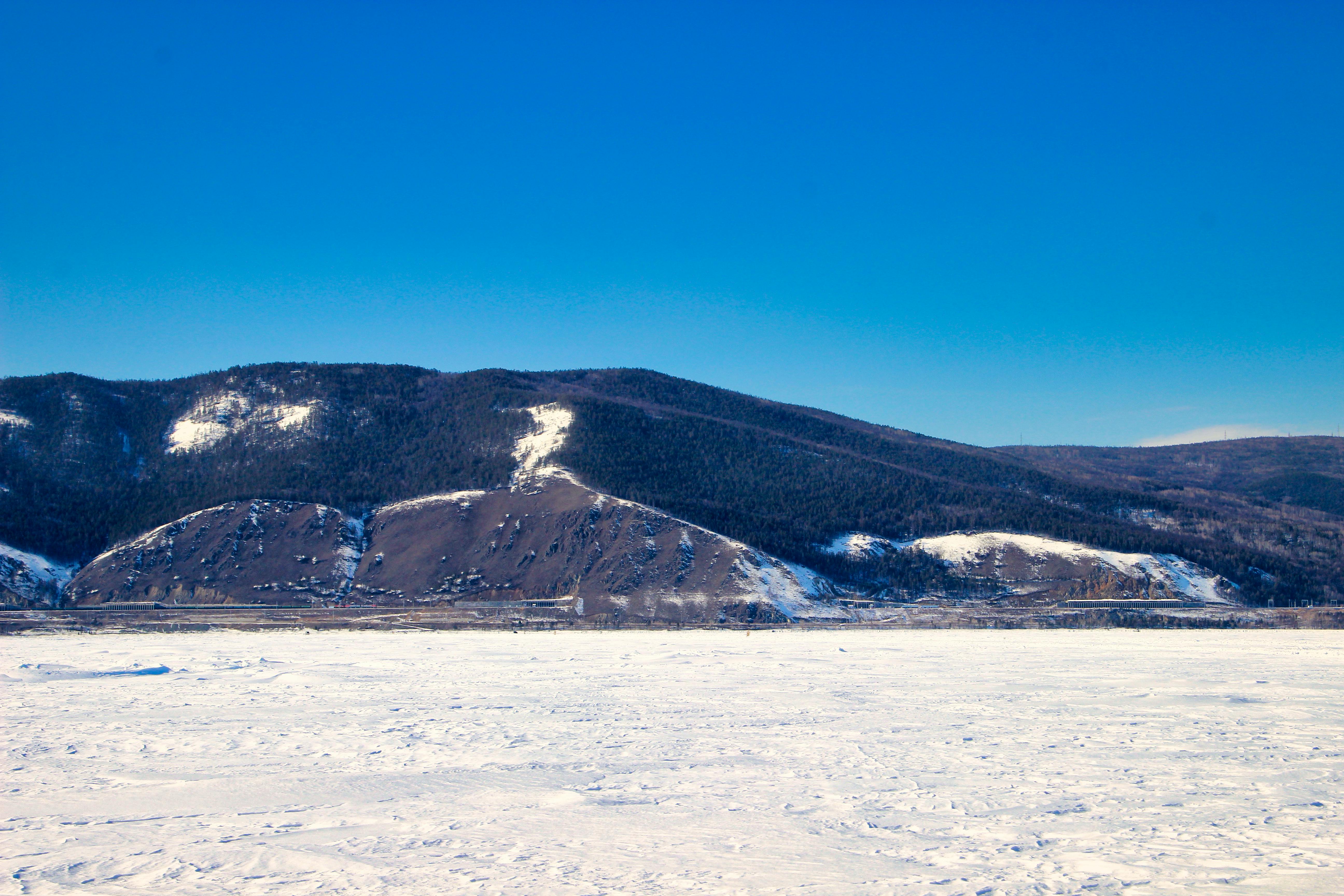 a snow covered mountain with a blue sky