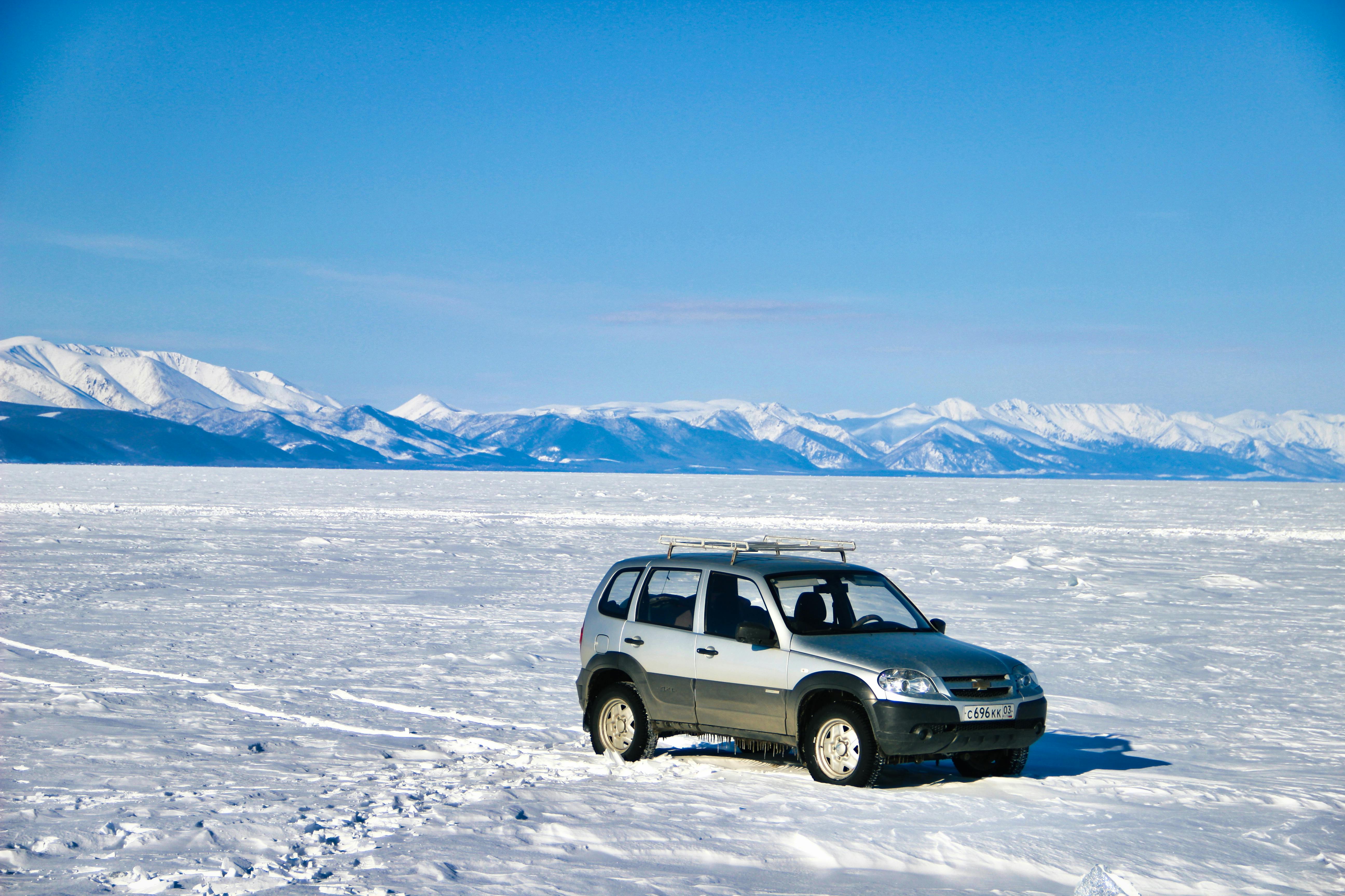 a car is parked on the snow covered ground