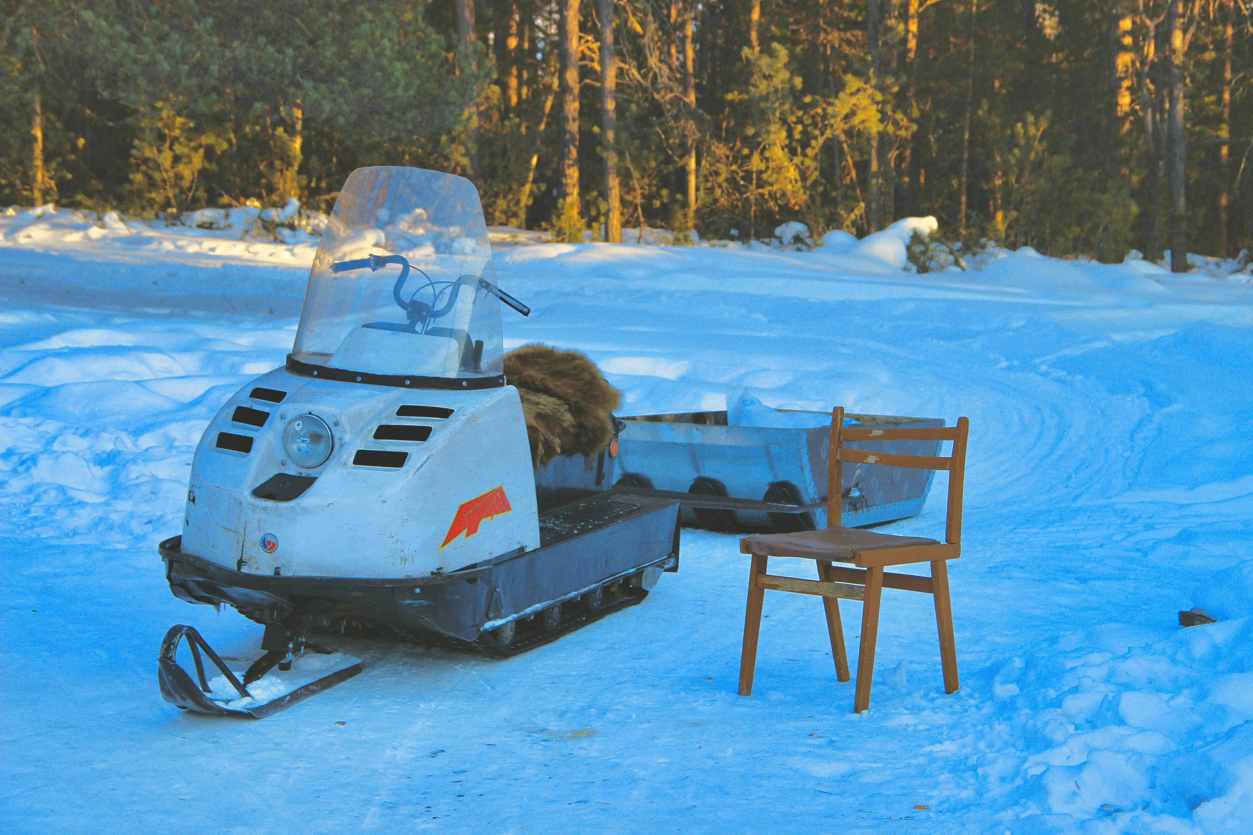 a snowmobile and a chair in the snow