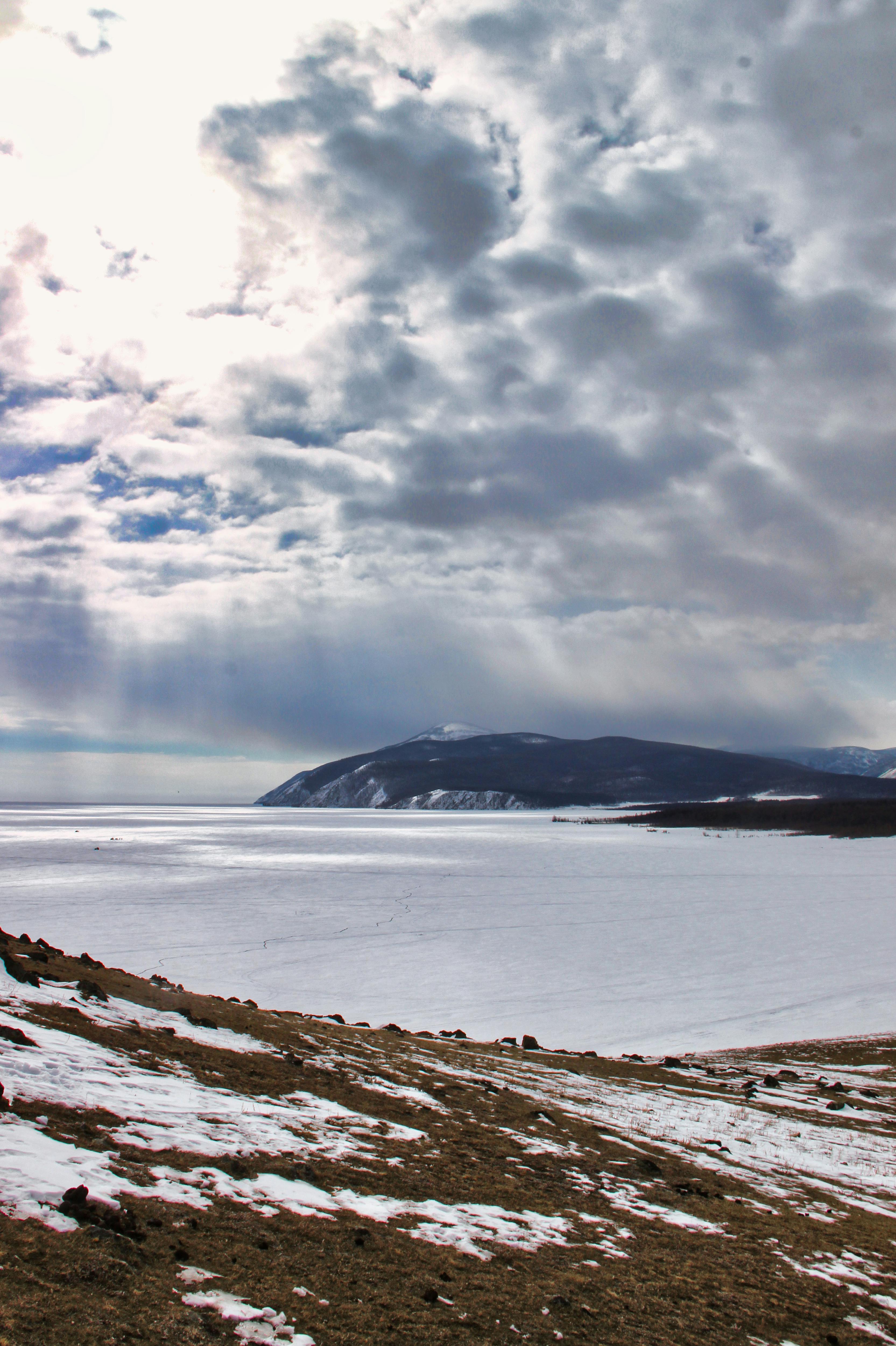 a view of a snowy landscape with a body of water