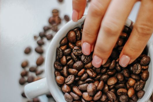 coffee grains and hand