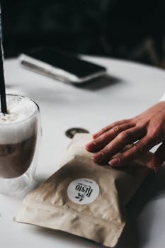 A woman enjoying a cappuccino in a cozy café setting, capturing a tranquil moment with a coffee bag.