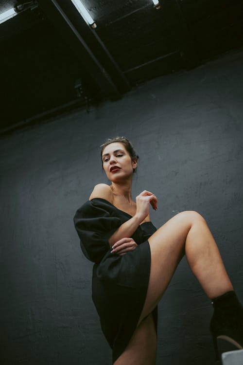 Low Angle Shot of a Woman in a Black Dress