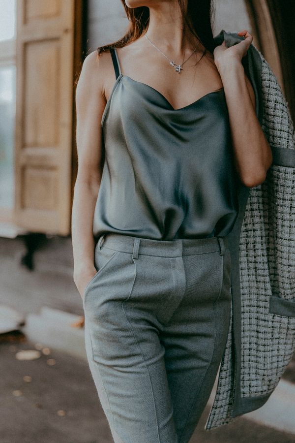 Woman wearing a satin camisole with trousers for work evening