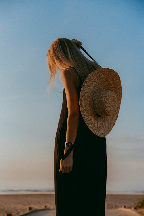 Woman in a Black Dress and Straw Hat 