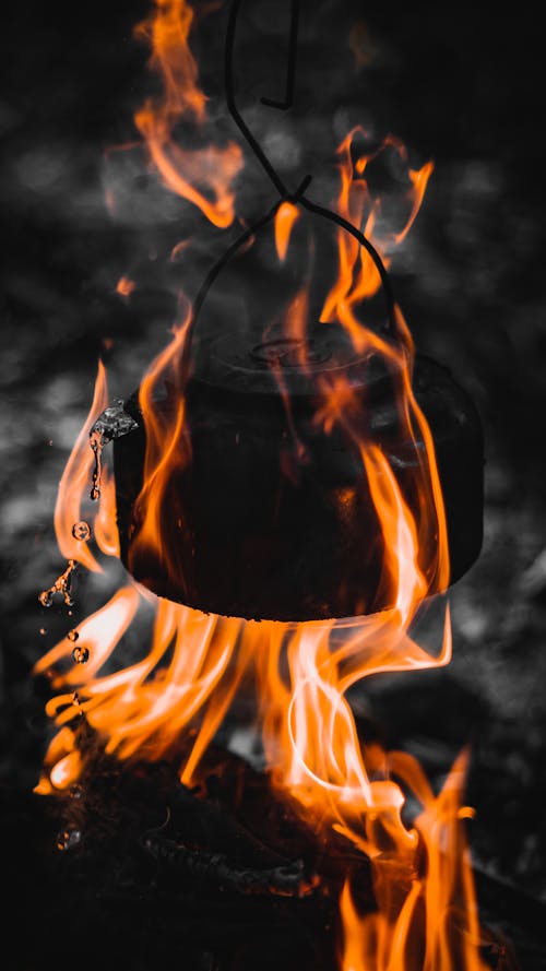 A black and white photo of a kettle on fire