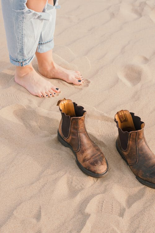 Woman Feet on Sand near Shoes