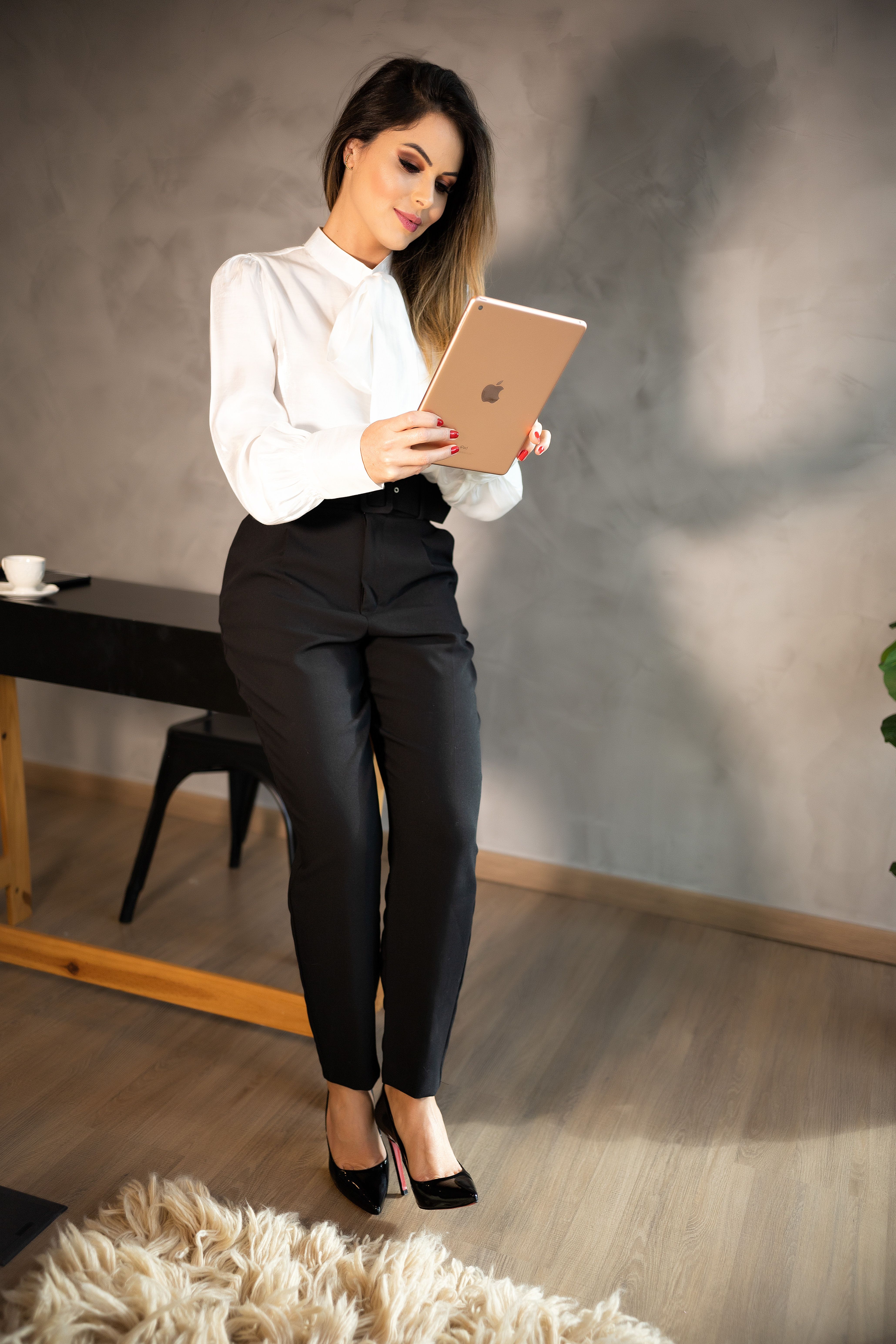 Woman wearing a statement sleeve blouse with tailored trousers