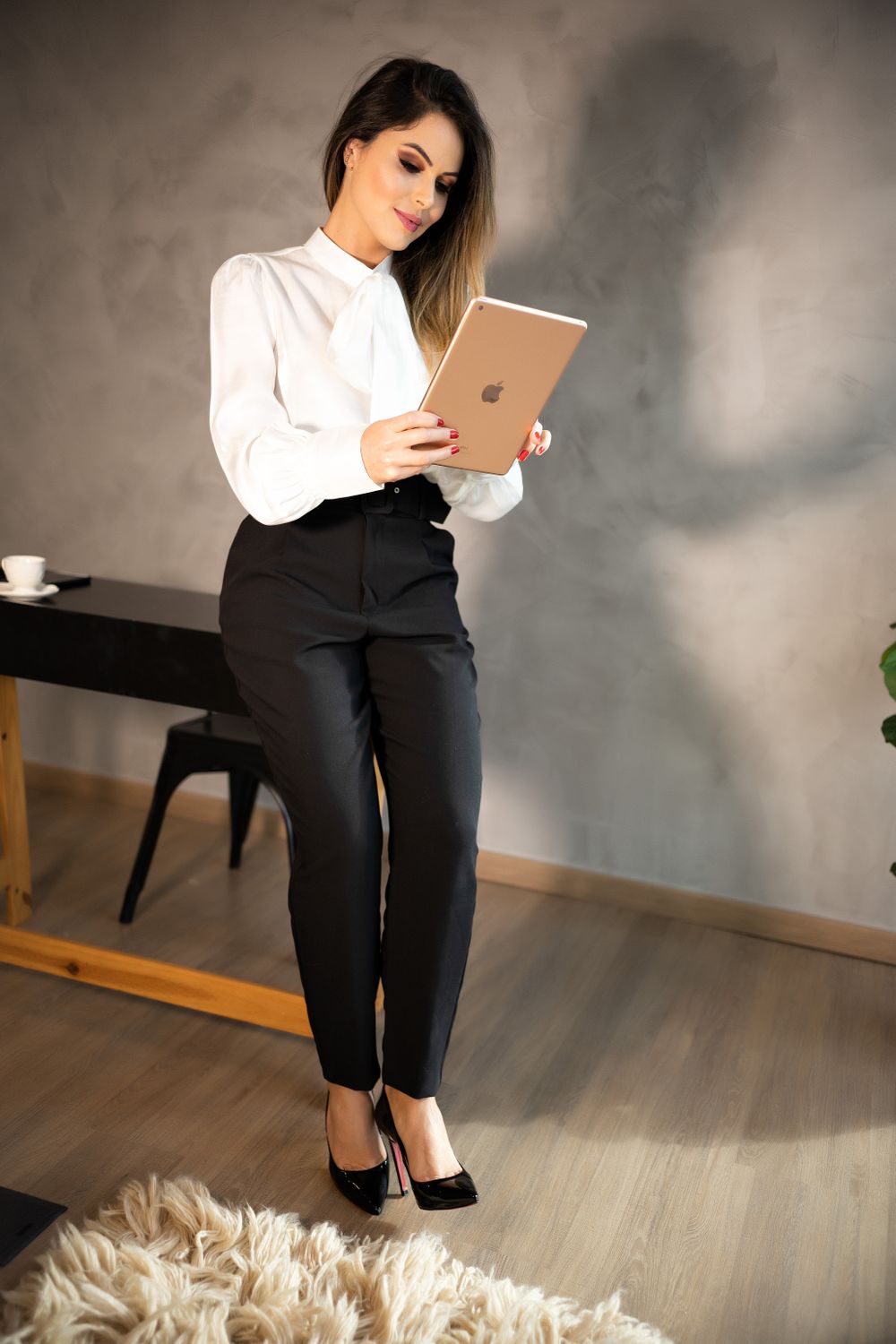 Woman wearing a statement sleeve blouse with tailored trousers