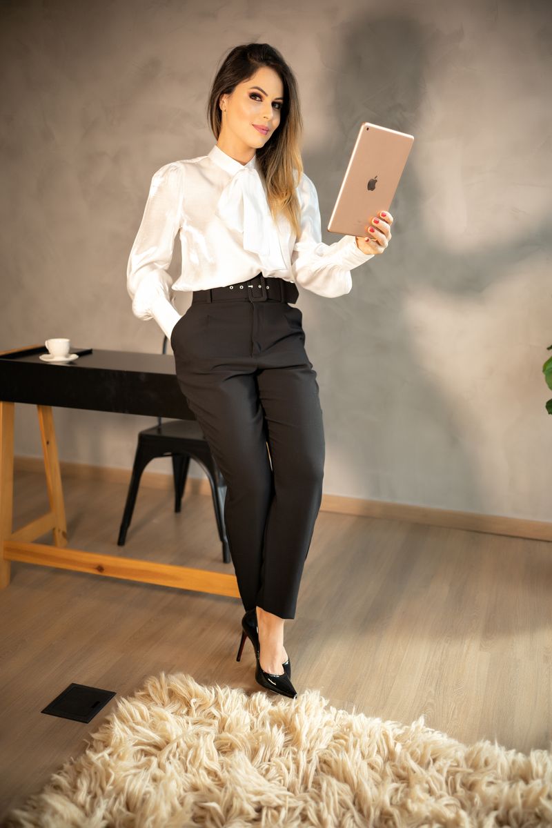 woman in ivory silk blouse and black cigarette pants