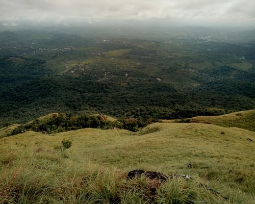 Free A breathtaking aerial view of rolling hills and dense forests in Kerala, India. Stock Photo