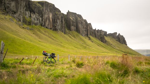 Explore the wild Icelandic highlands on a bikepacking adventure with cliffs and grassy meadows.