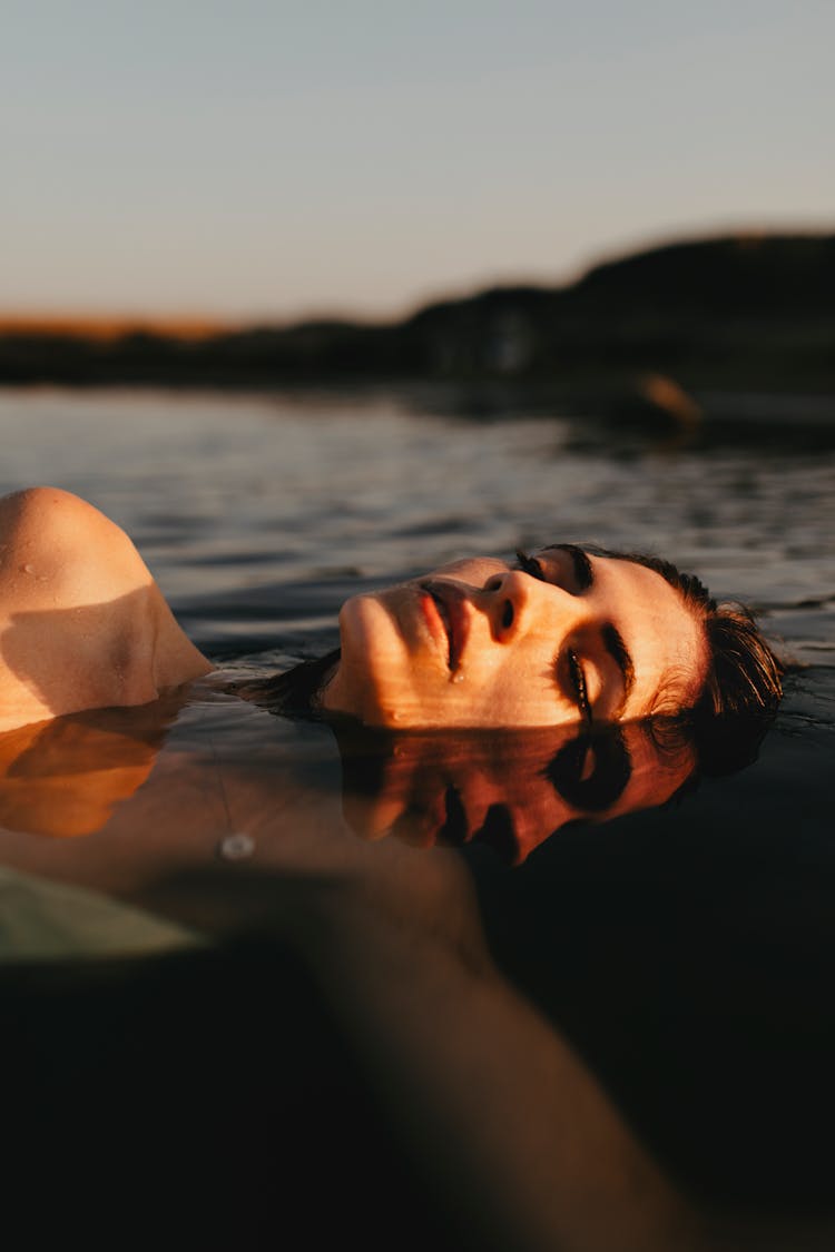 Face Of Woman Reflecting In Water