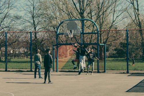 Boys Playing Basketball Outdoors 