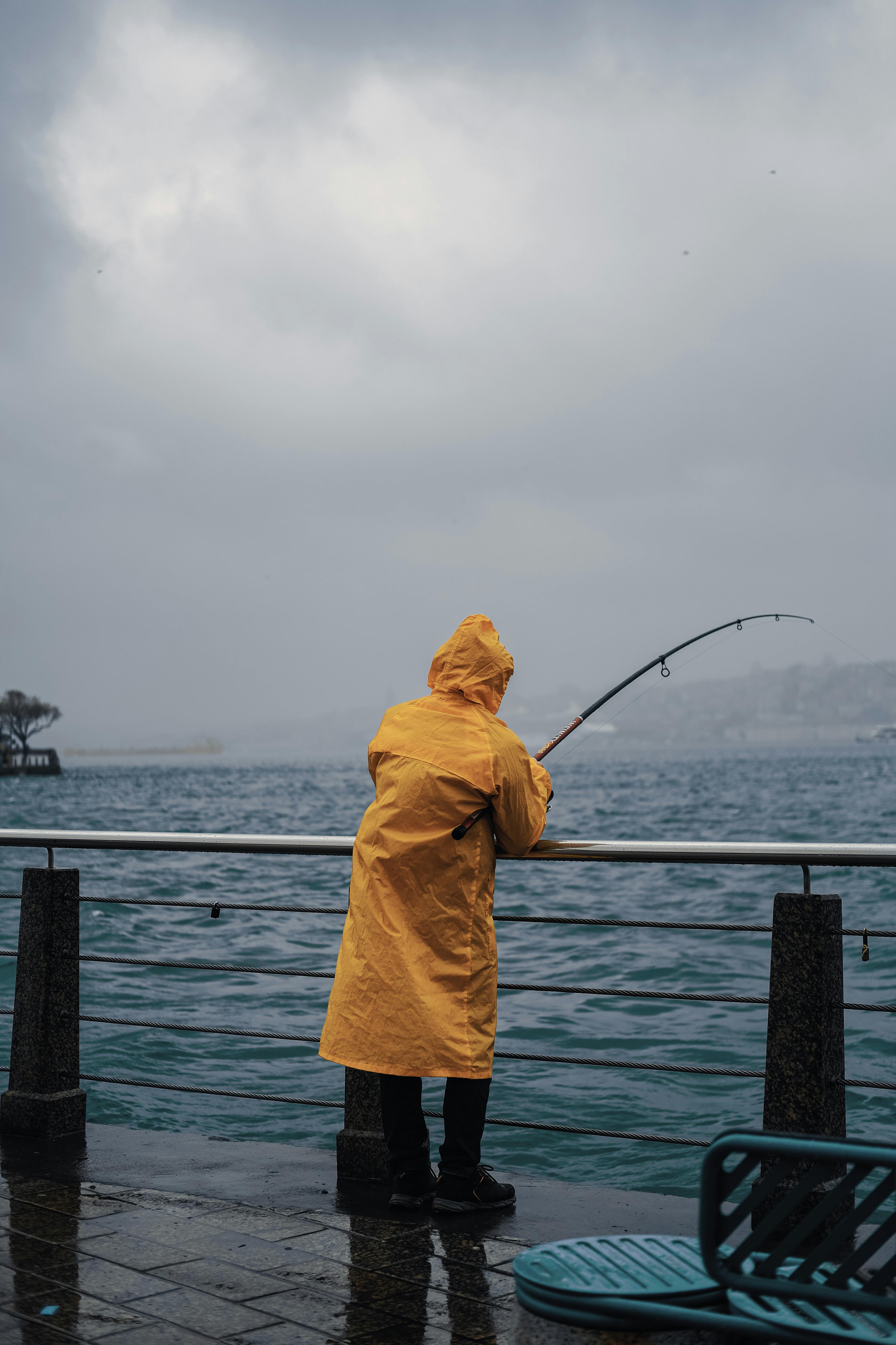 Boy Feeling Surprised. Boy Wearing Yellow Raincoat Feeling Surprised While  Seeing Fish In The Fishing Net Stock Photo, Picture and Royalty Free Image.  Image 128998560.