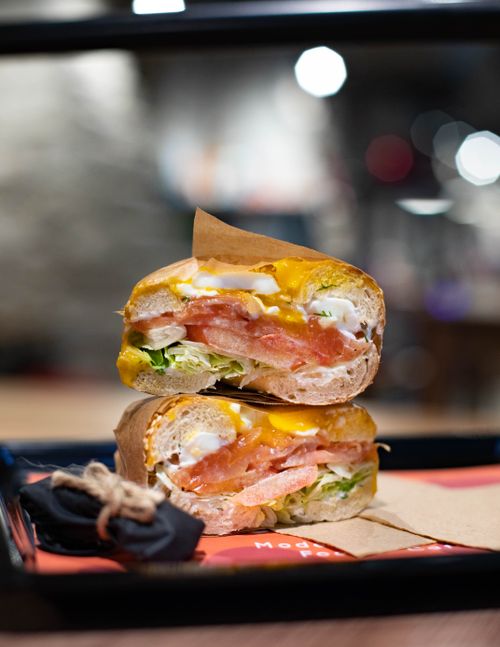 Free Appetizing stacked sandwich with vegetables and cheese on a table indoors. Stock Photo