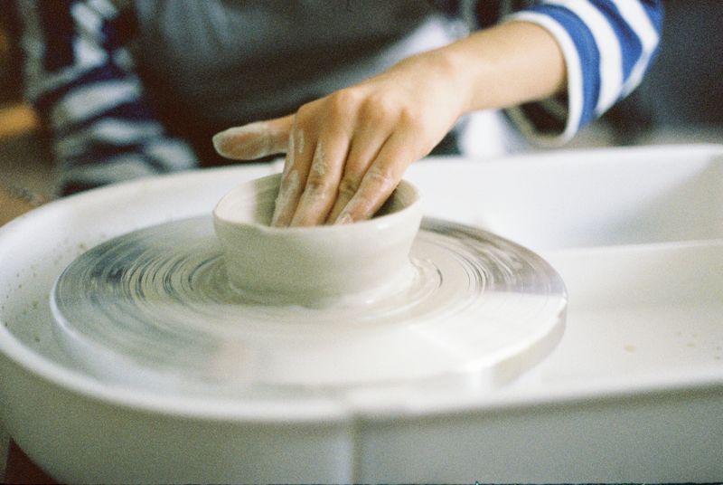 hands shaping a bowl on a potter's wheel — photograph by Rüveyda on Pexels