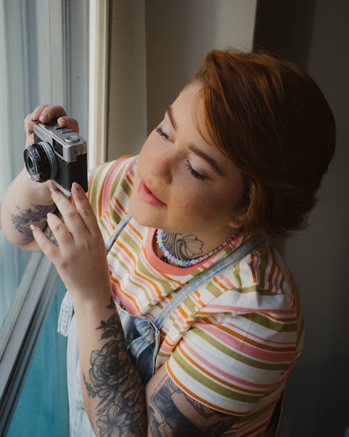 Woman With Vintage Camera by Window