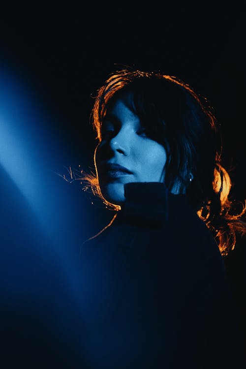 Woman with Black Hair Posing in Darkness