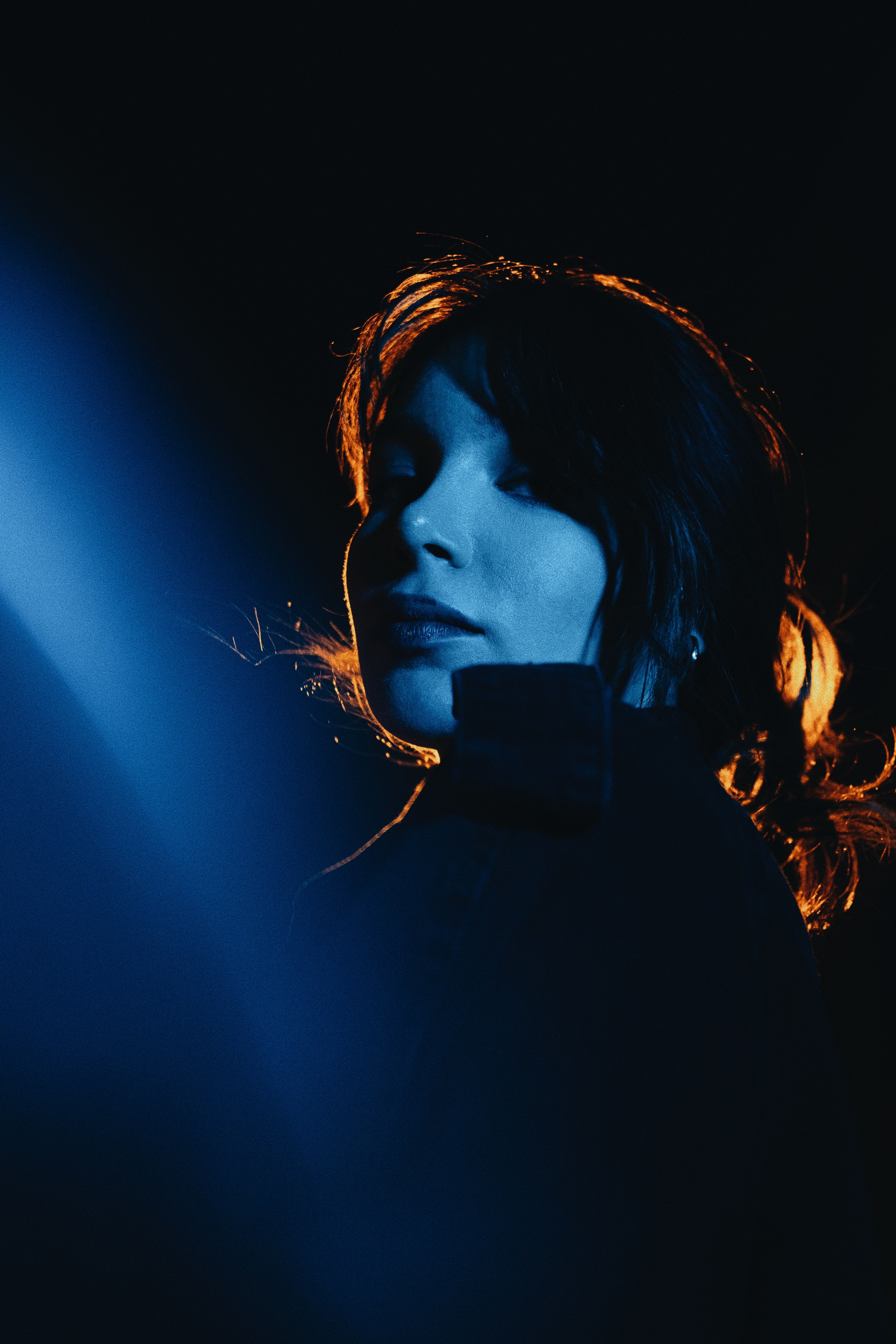 Woman with Black Hair Posing in Darkness · Free Stock Photo