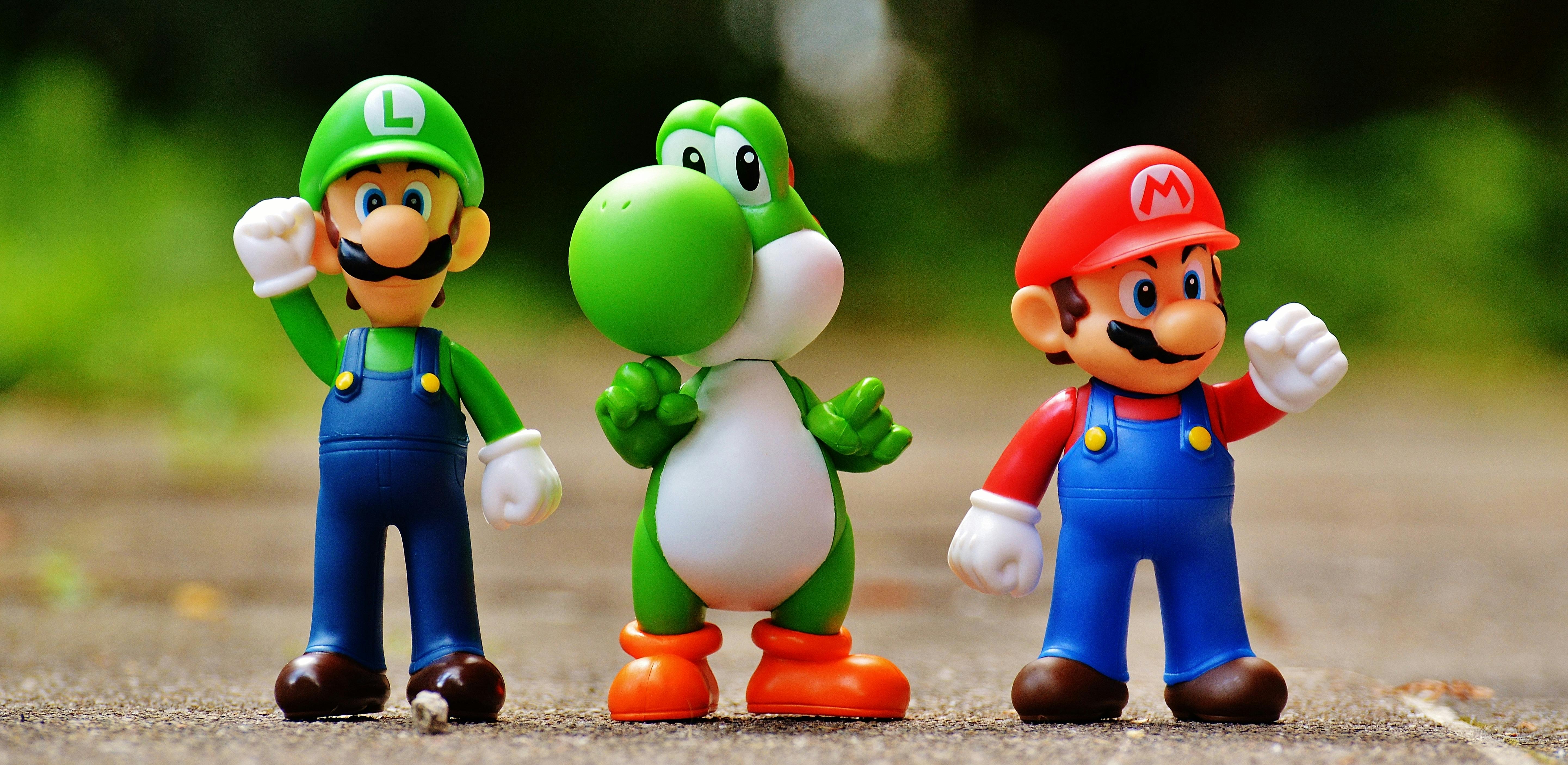 focus photo of super mario luigi and yoshi figurines