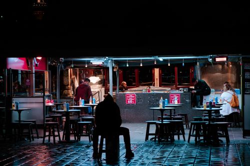 Free Captivating night shot of street food scene with people in city ambience. Stock Photo