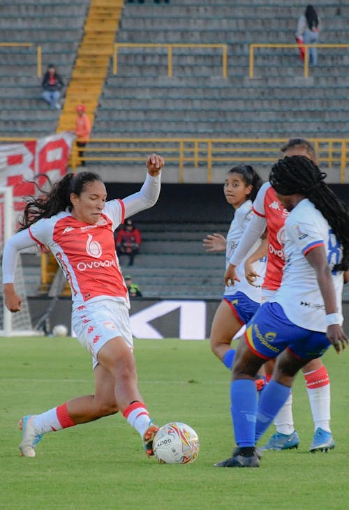 Women Playing Football on Stadium
