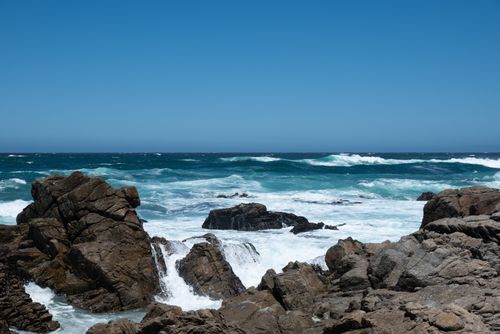 Free Dramatic ocean waves crashing against rugged rocks in California's coastline. Vivid blue sea scenery. Stock Photo