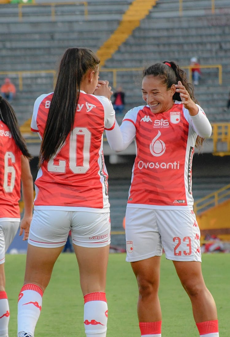 Female Players Cheering A During A Soccer Match