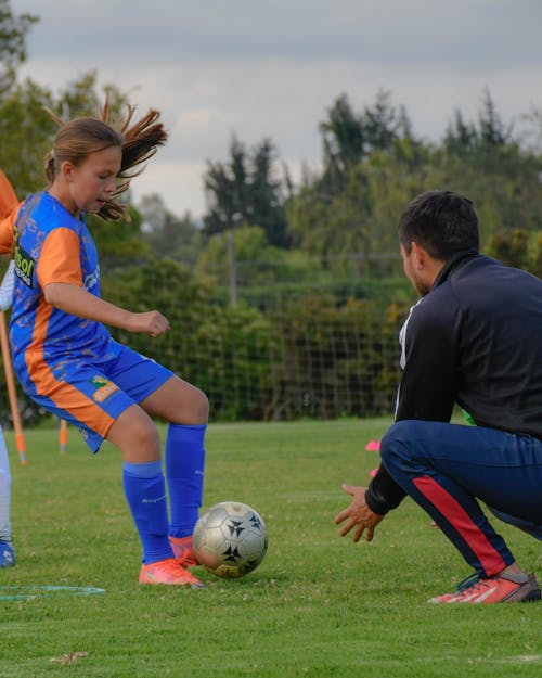 A Girl and a Coach at a Soccer Training 