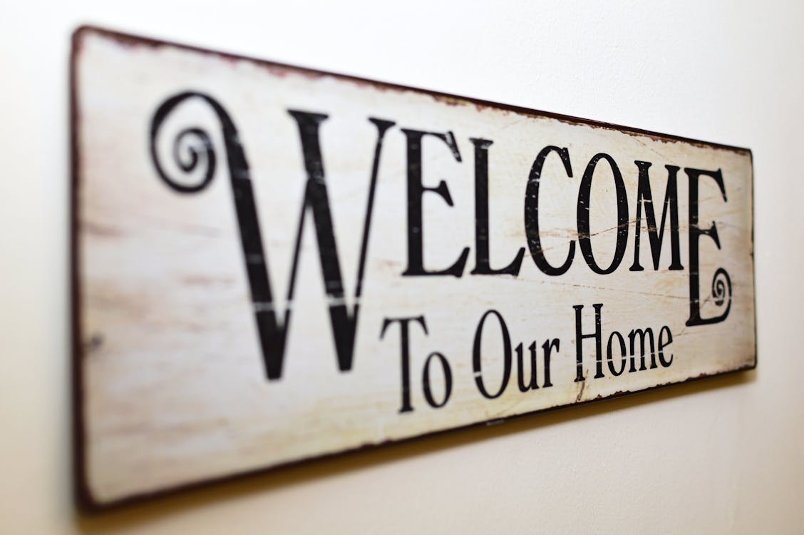 Free Welcome to Our Home Print Brown Wooden Wall Decor Stock Photo