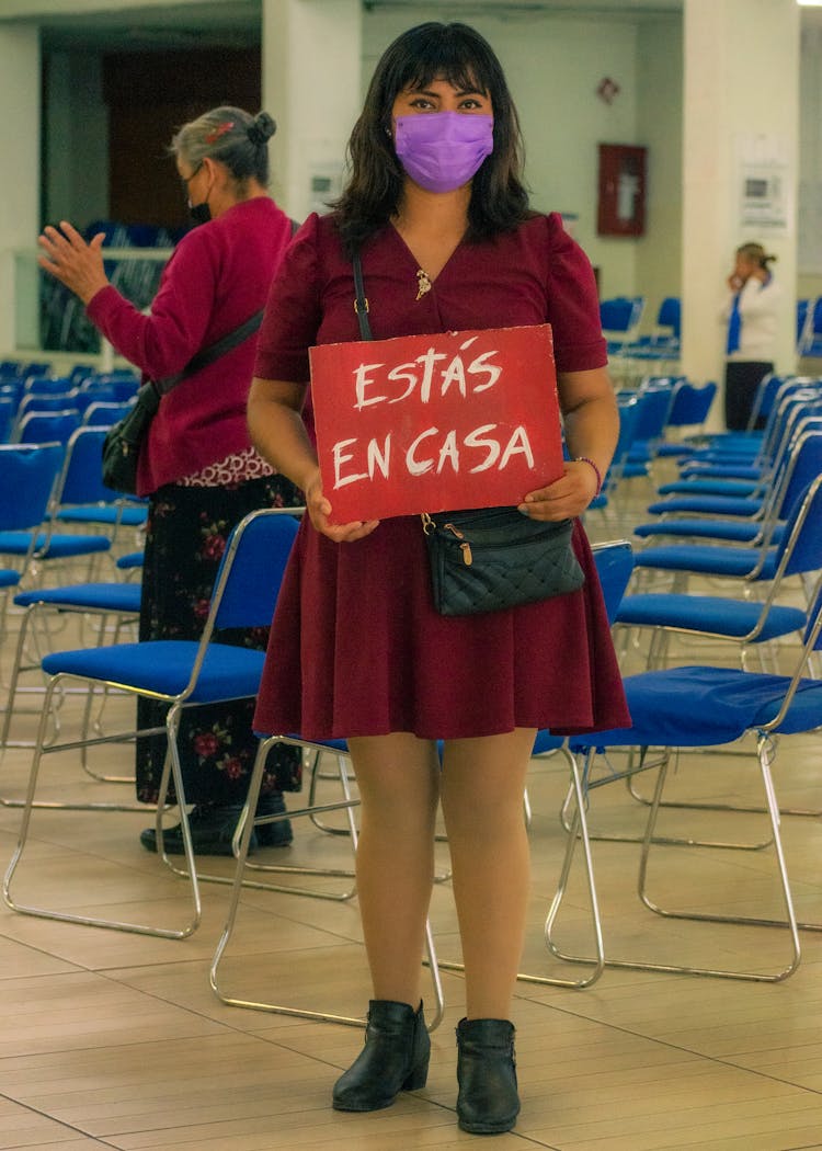 A Woman Holding A Sign 