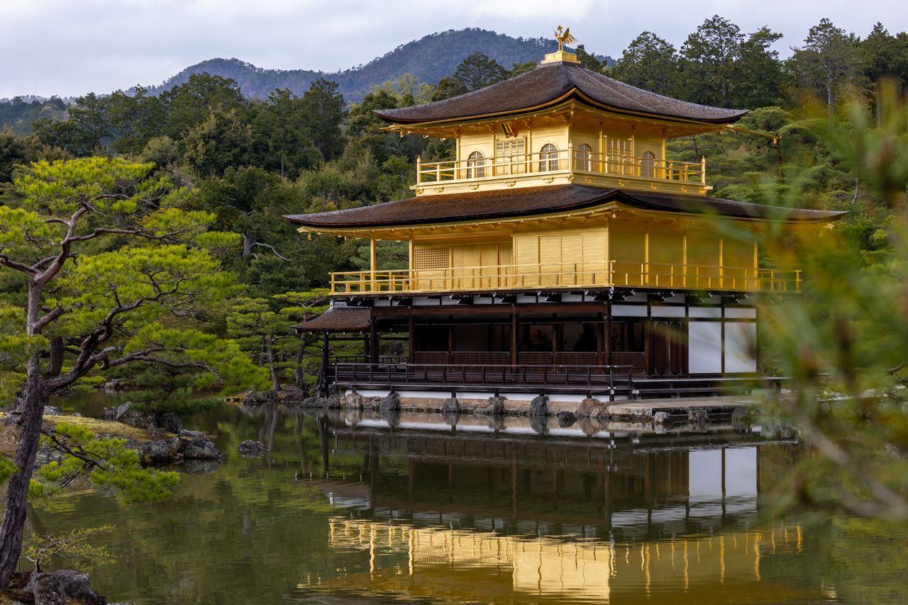the kinkaku ji or golden pavilion temple beautifully reflects in the l