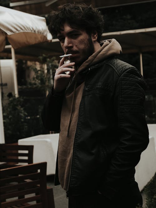 Man Smoking a Cigarette on a Street