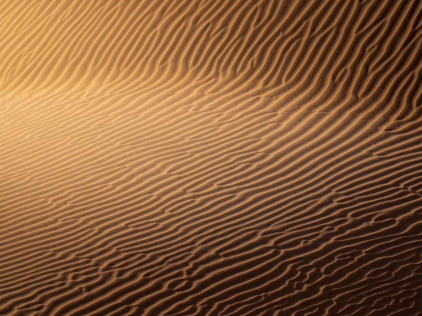 Mesmerizing close-up of golden sand dunes highlighting intricate patterns and textures.