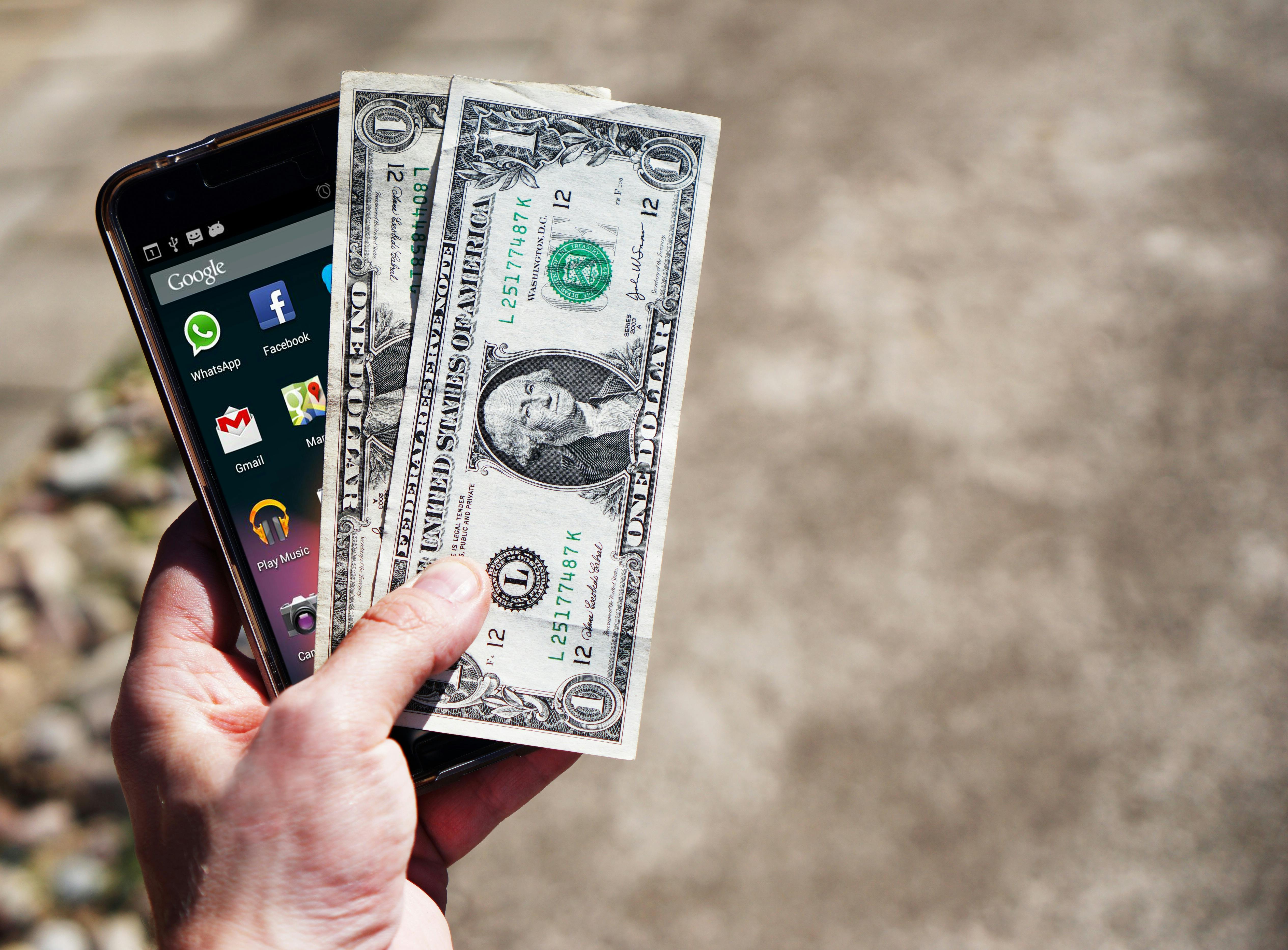 mobile-phone-money-banknotes-us-dollars-163069.jpeg?cs=srgb&dl=hand-smartphone-mobile-phone-163069.jpg&fm=jpg