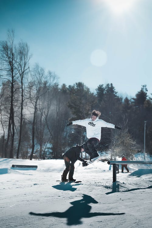 Person Jumping While Using Ski Board