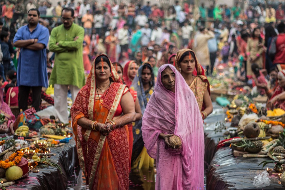 Crowd gathered at a traditional cultural festival with colourful decorations