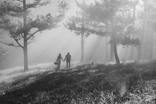 Grayscale Photography of Man and Woman Holding Hands