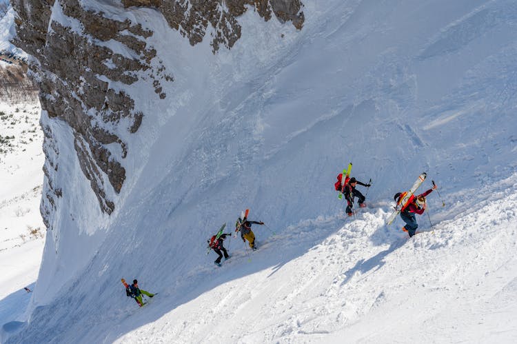 People Climbing A Mountain In Winter 