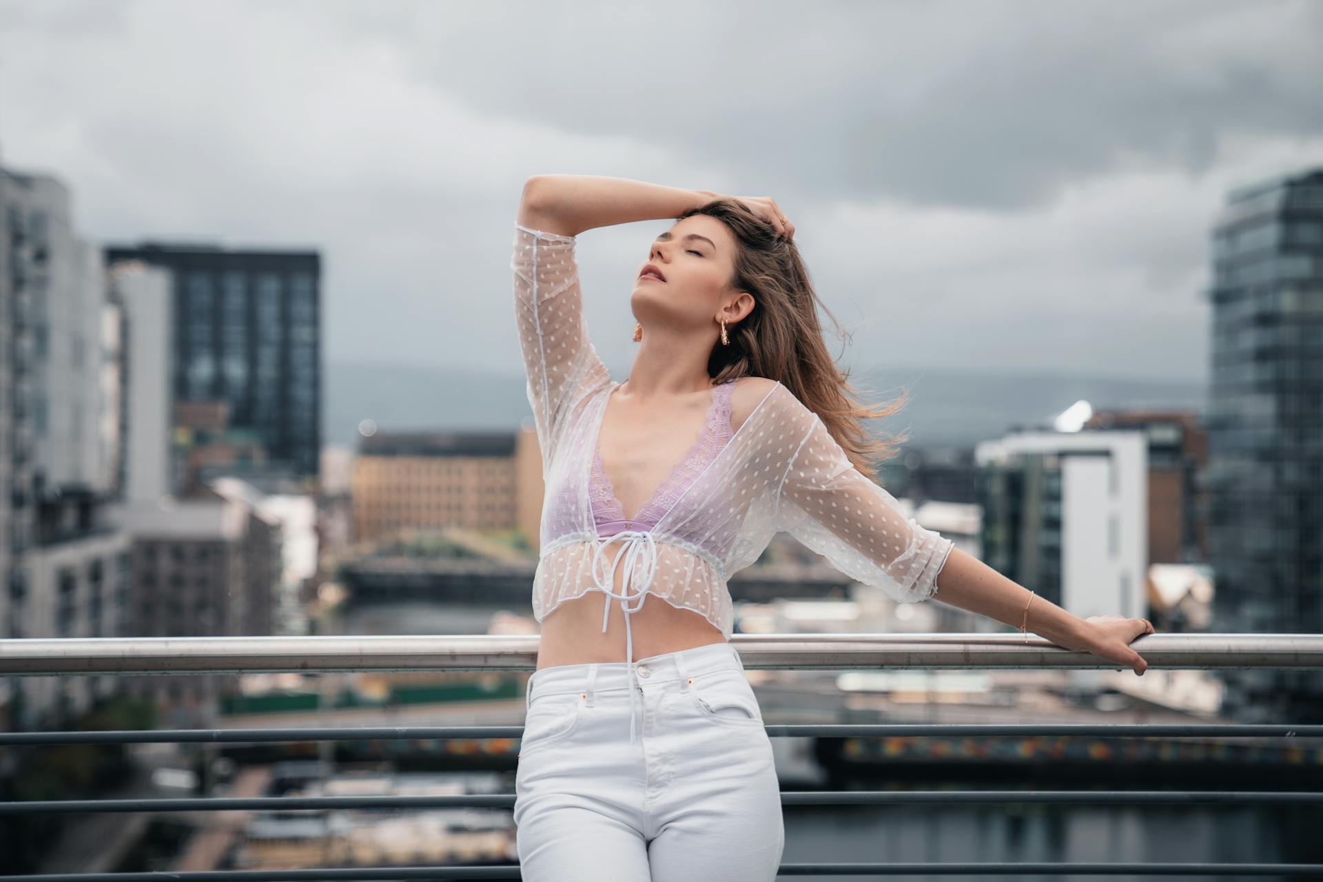 Urban fashion portrait of a woman posing confidently on a Dublin rooftop.