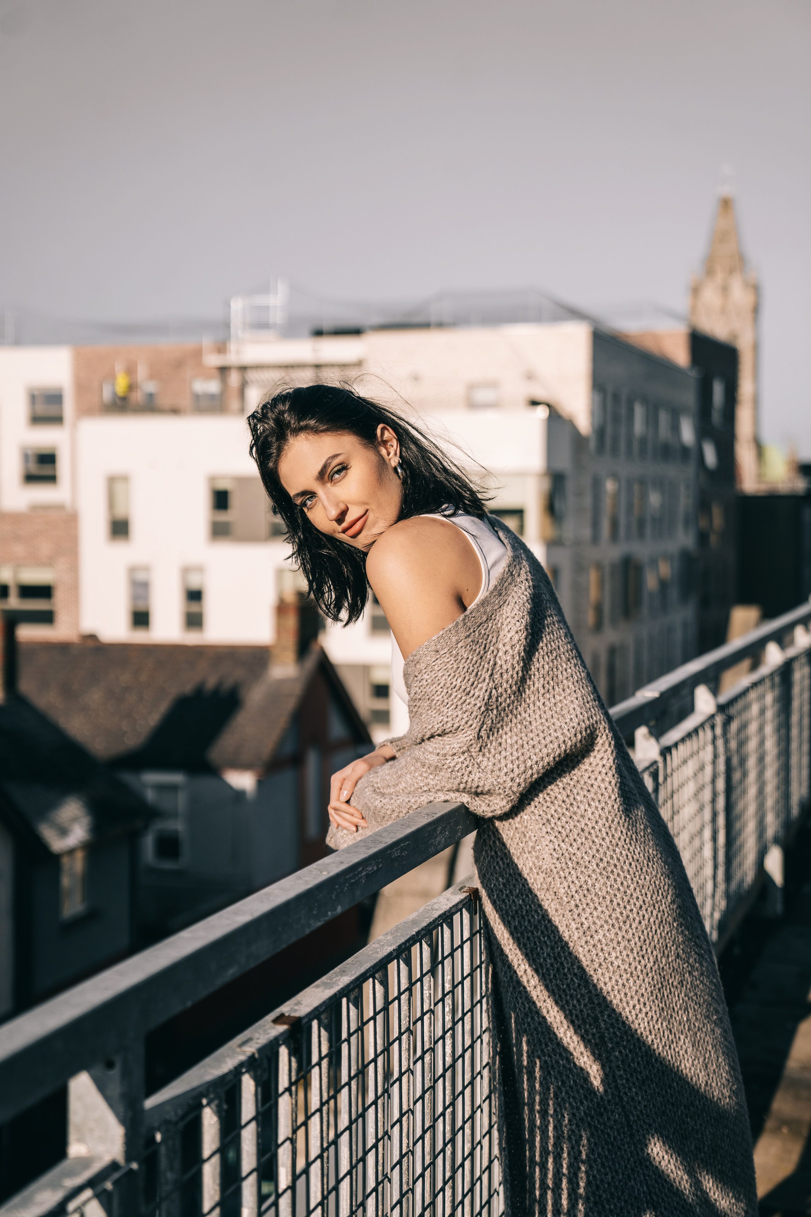 Woman Leaning on Railing and Posing · Free Stock Photo