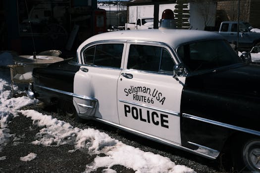 Retro police car in Seligman, Arizona, on snow-covered Route 66.