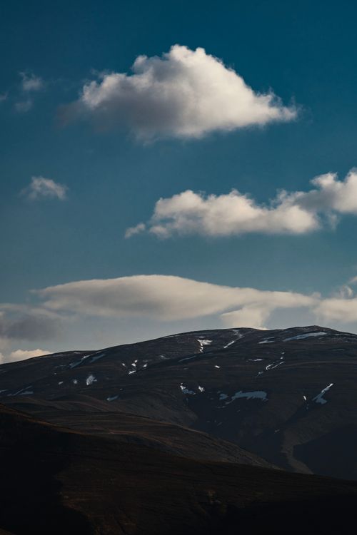 Free Tranquil scenic view of snow-capped mountains under a clear blue sky in Mashhad, Iran. Stock Photo