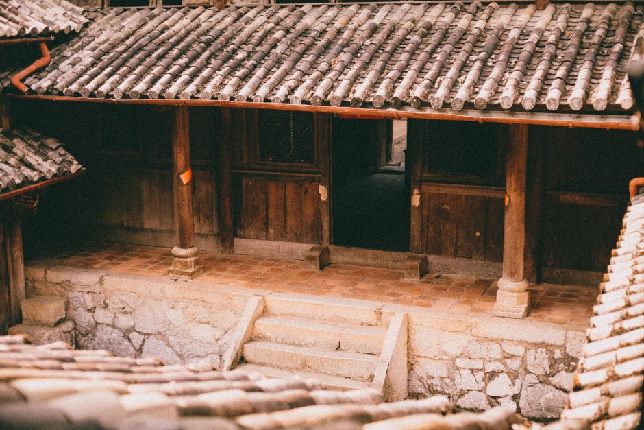 Charming traditional courtyard with wooden architecture and stone steps.