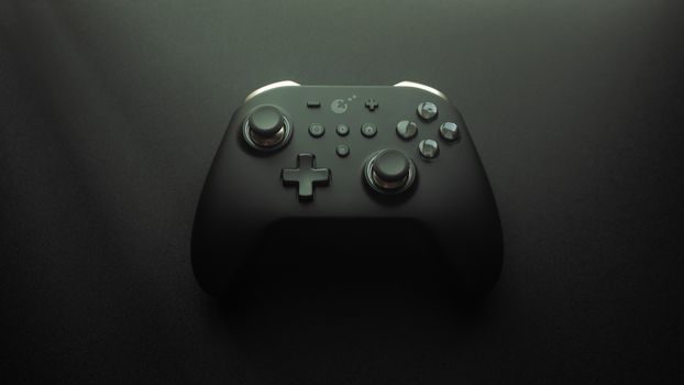 High-quality image of a modern game controller on a smooth black surface, highlighting design and technology.