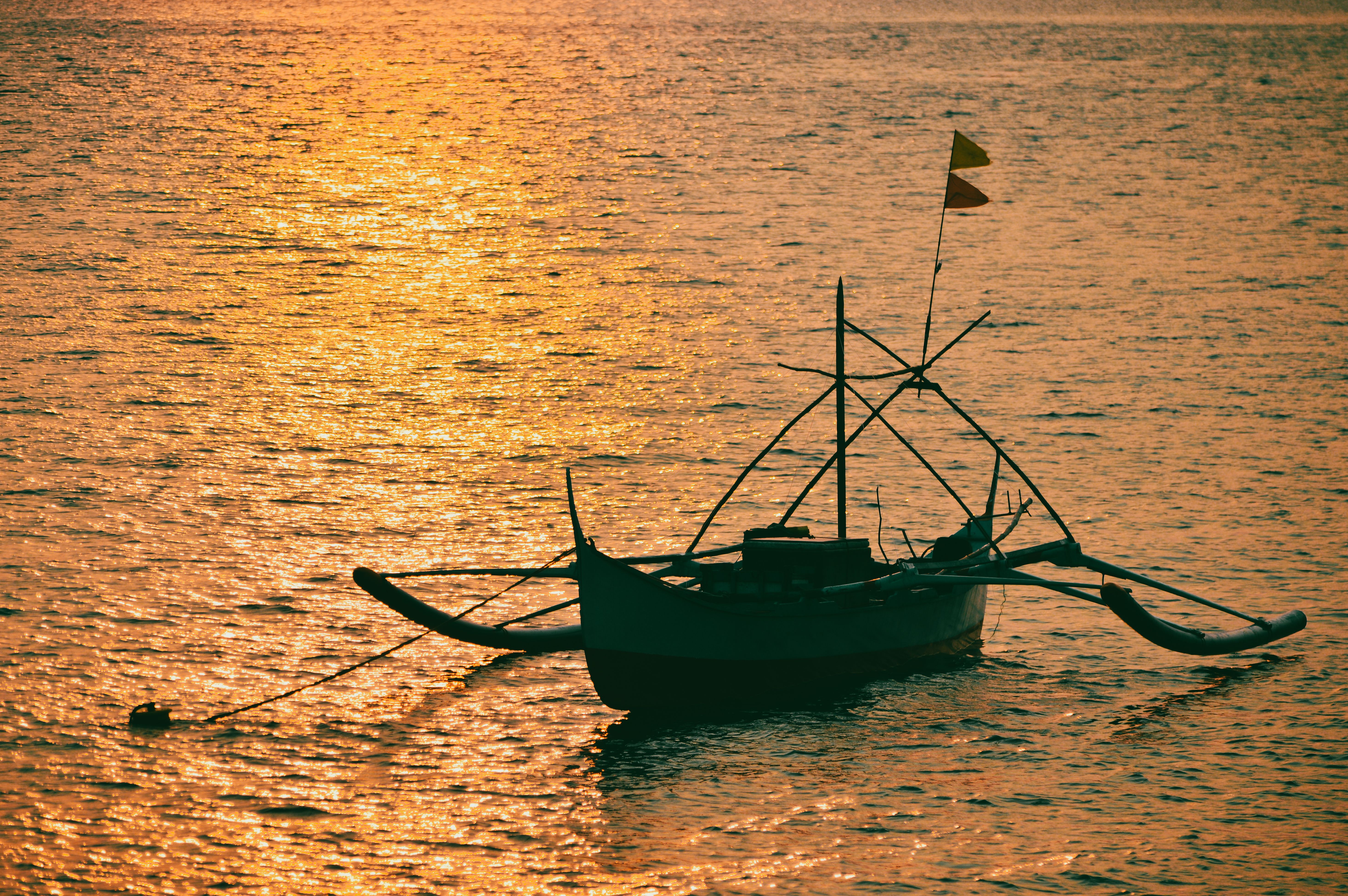 Silhouette of Boat Sailing in Water on Sunset · Free Stock Photo