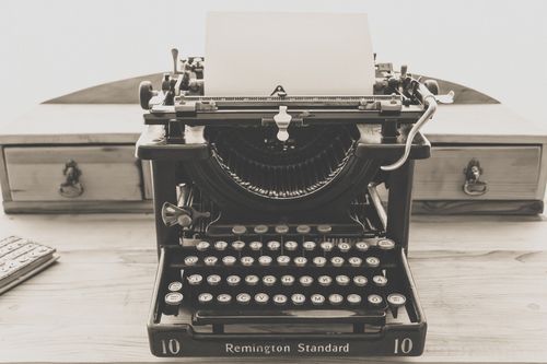 Free Sepia-toned image of a classic Remington typewriter, perfect for vintage themes. Stock Photo